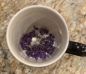 A mug from above, with some lavender petals at the bottom