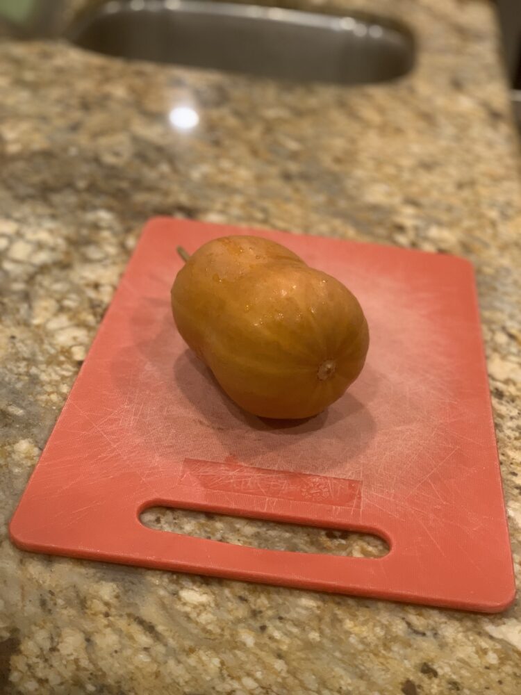 A honeynut squash on a cutting board