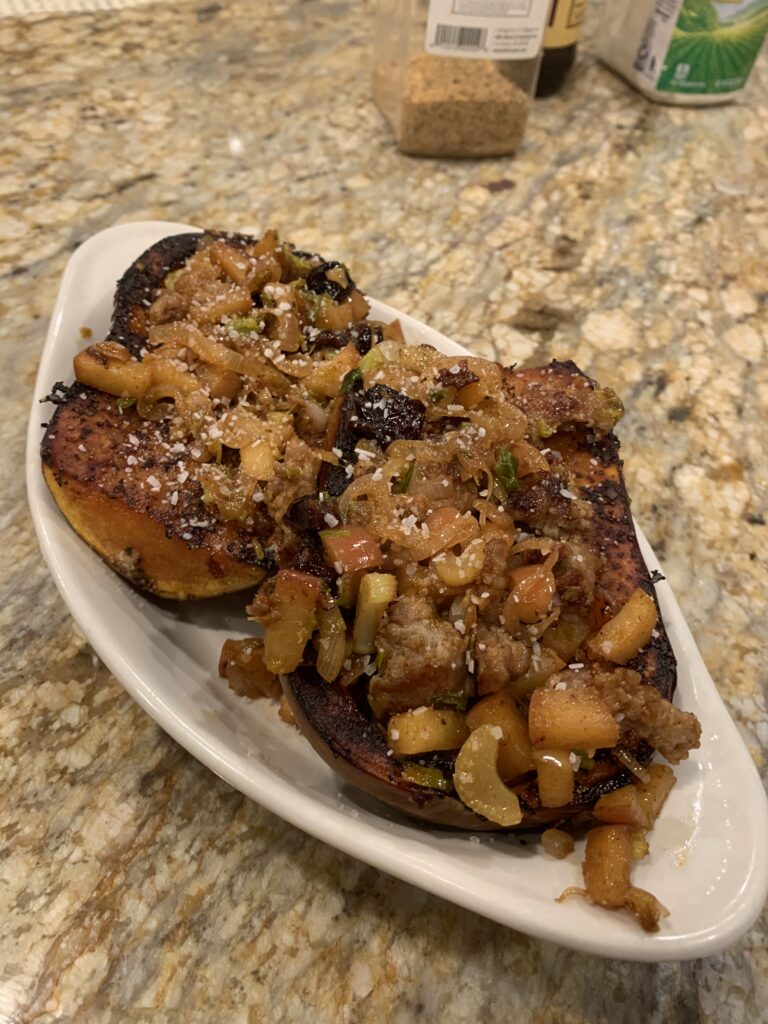 A ceramic boat with a roasted and stuffed squash 